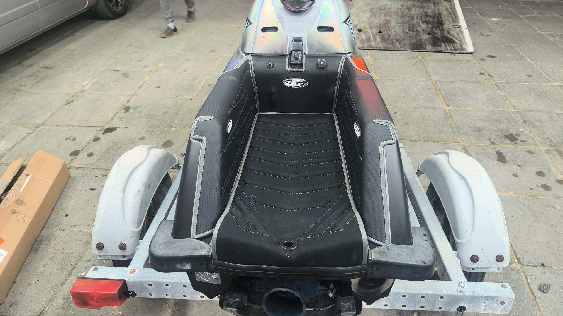 Black and gray custom jet ski seat upholstery installed on a personal watercraft by Shakeel Marine in Kuwait